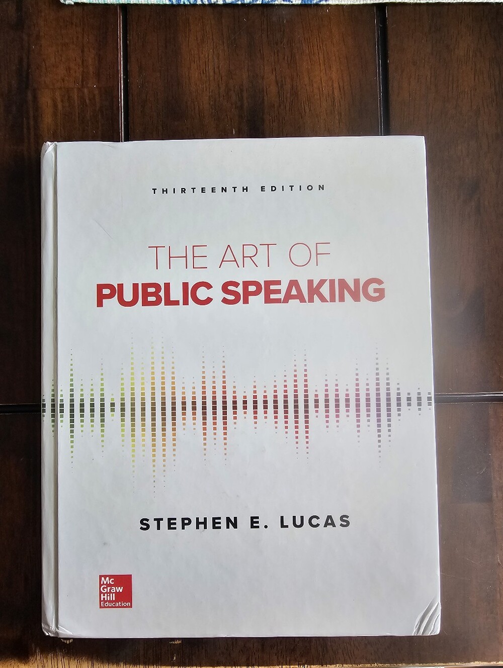 The Art of Public Speaking 13th by Stephen E. Lucas — White Cover with Red Title